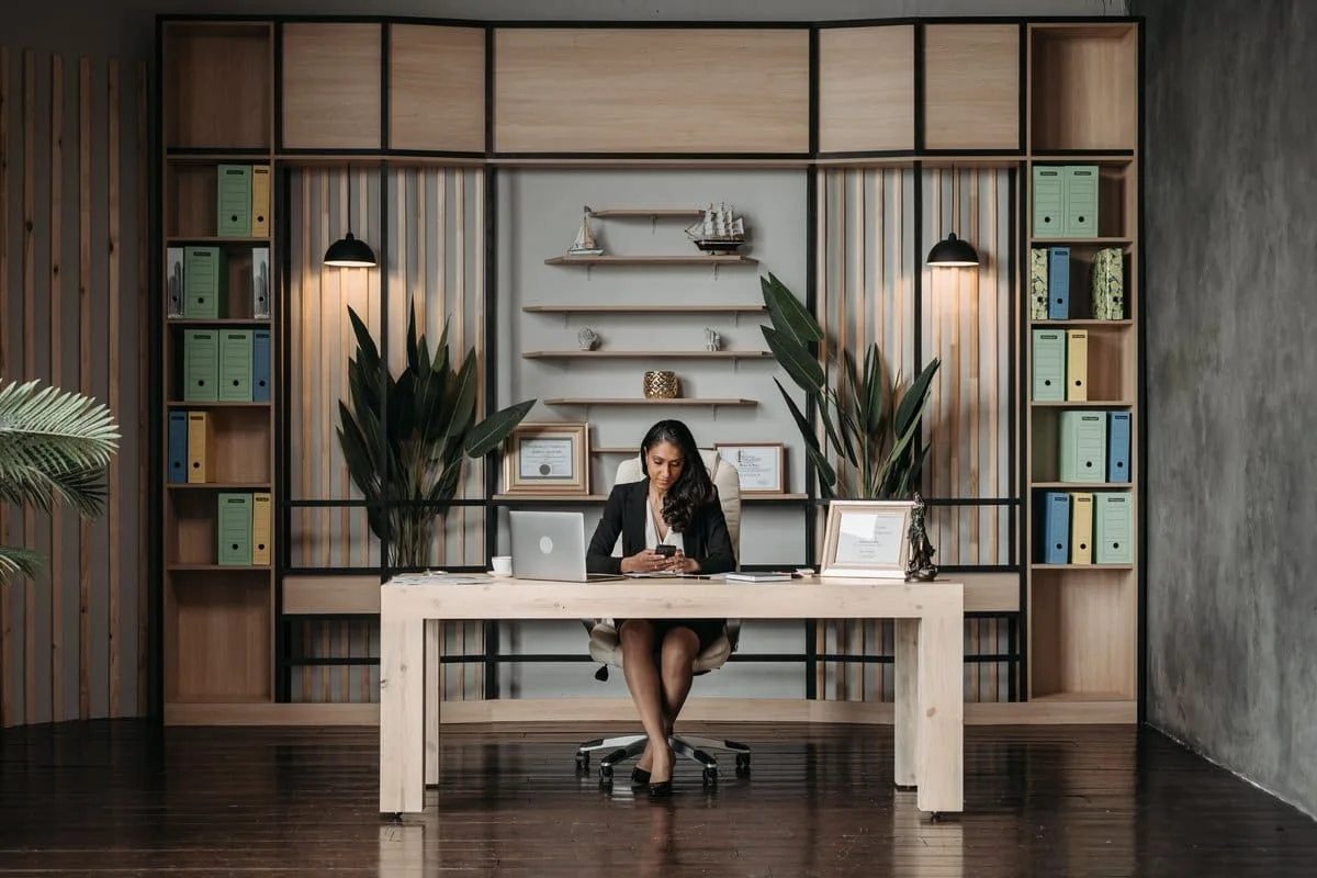 A professional working at a desk with organized document folders, representing paralegal certification study and case preparation