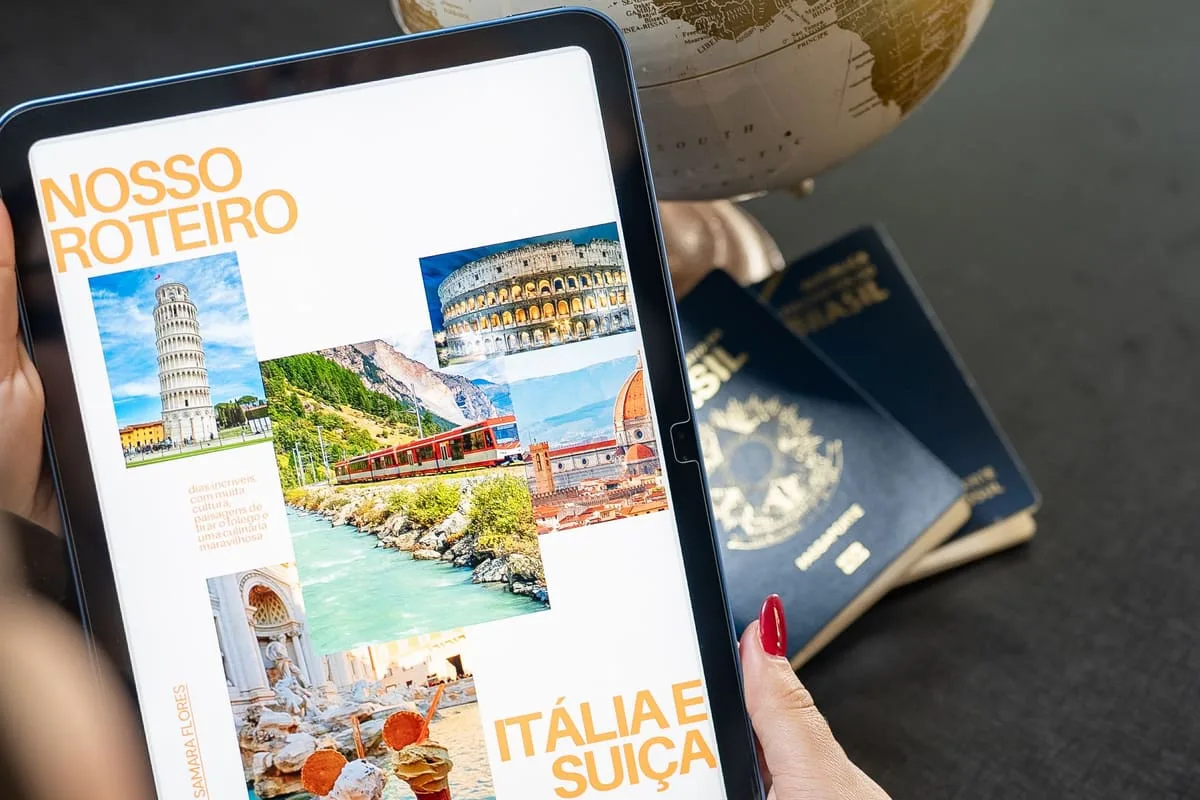 A traveler planning a multi-country trip using a globe, tablet, and passports laid out on a desk